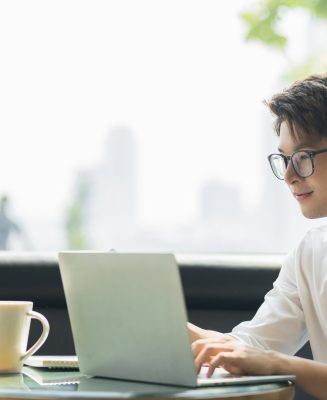 Smart attractive positive asian business male wearing glasses work remote new normal lifestyle hand use laptop tele conference onlive videocall meeting remote business ideas concept